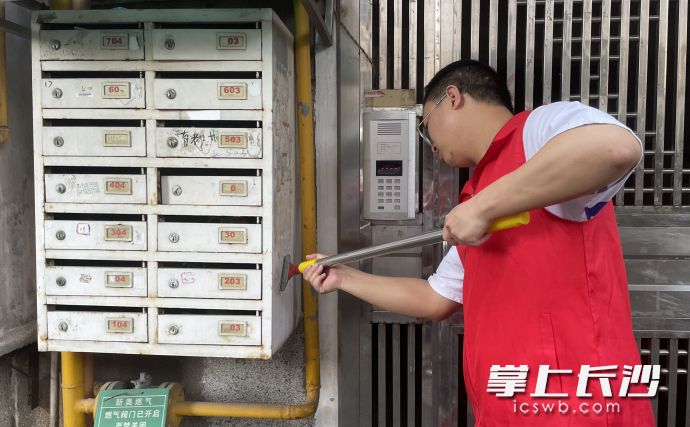 清水塘街道省公路局小區(qū)內(nèi)，志愿者對“牛皮癬”進(jìn)行清理,。