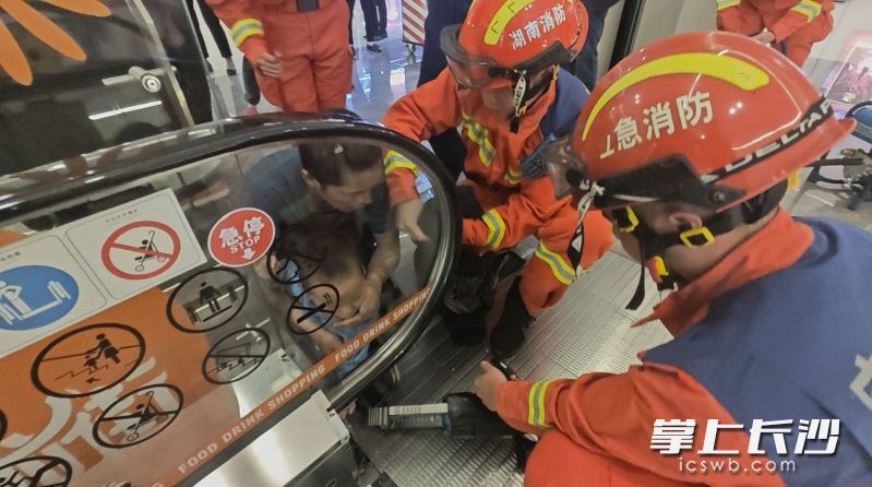 消防員正在救援被扶梯卡手的兒童,。 長沙晚報通訊員 楊慧 供圖