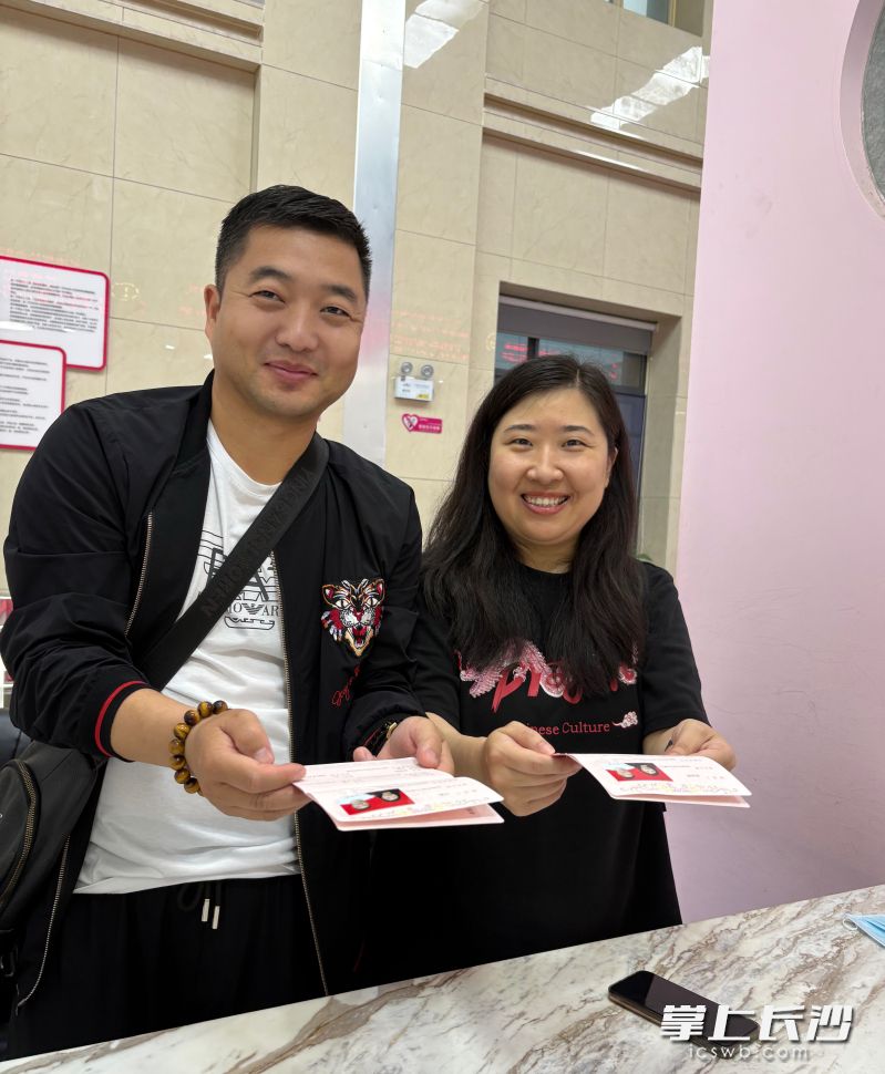 領到結婚證的馬先生夫妻滿臉笑容。 均為通訊員供圖