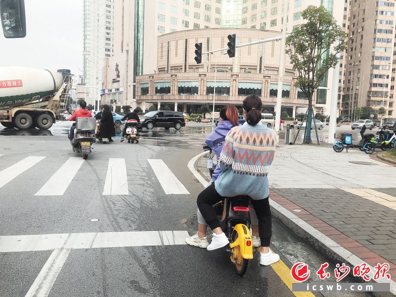 滾滾車流中，一對(duì)閨蜜一同騎共享電動(dòng)車出行,。長(zhǎng)沙晚報(bào)全媒體記者 張洋子 攝