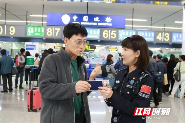 A customs official answers questions from a traveler.?