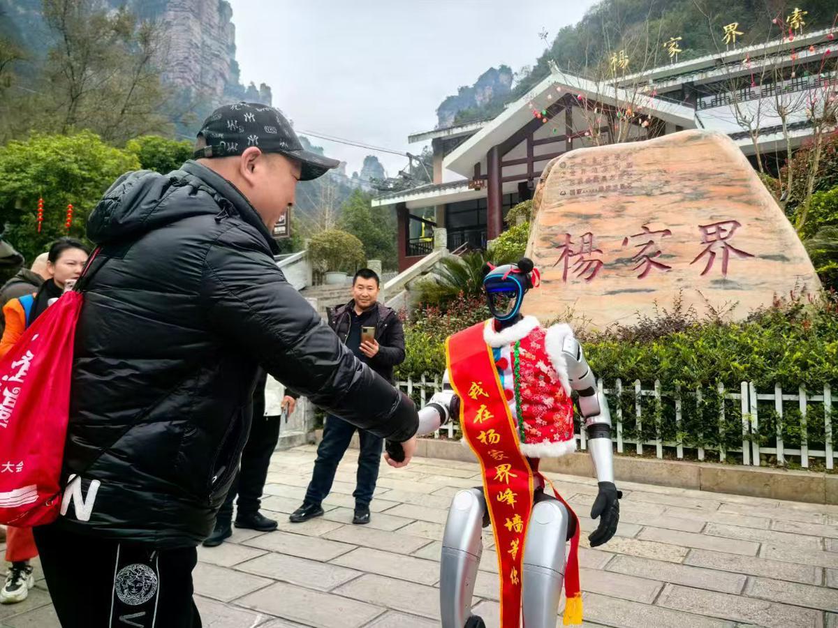Robots and robotic dogs warmly greet tourists in Zhangjiajie, Hunan province. [Photo provided to chinadaily.com.cn]